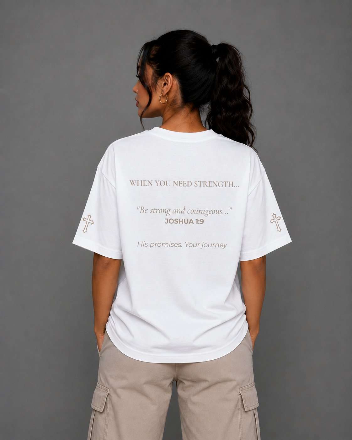 Back view of white Courage T-shirt from the Soul Kreations Luxe Promise Collection featuring Joshua 1:9 scripture design and embroidered cross sleeve details. ✨