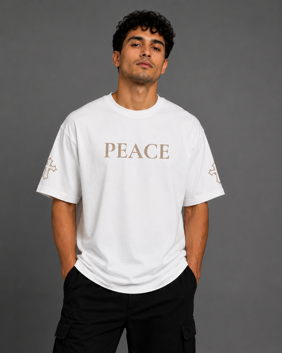 Male model wearing white Peace T-shirt with embroidered PEACE chest lettering and embroidered cross sleeve details from the Soul Kreations Luxe Promise Collection.