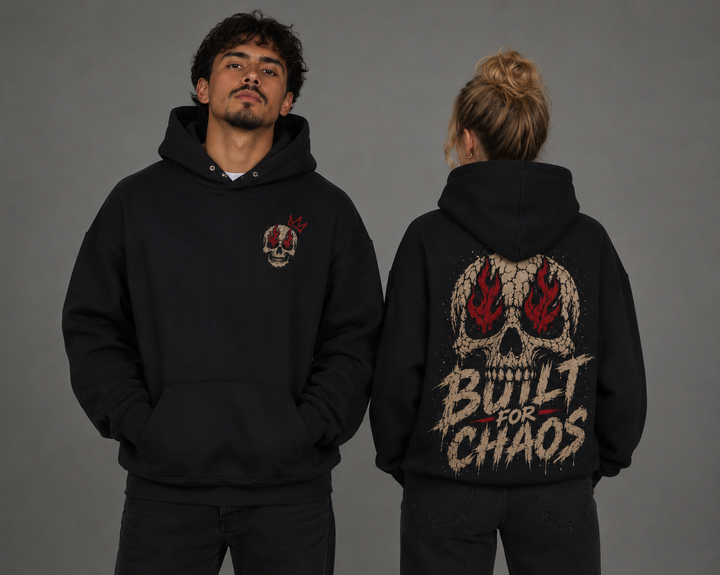 Male and female models showcasing a black “Built for Chaos” hoodie, featuring a small skull chest graphic on the front and a large distressed flaming skull design on the back.