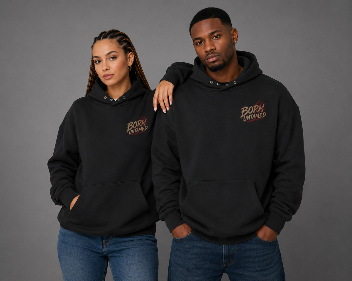 Male and female models wearing black “Born Untamed” hoodies, showcasing the small distressed chest logo with subtle red accents.