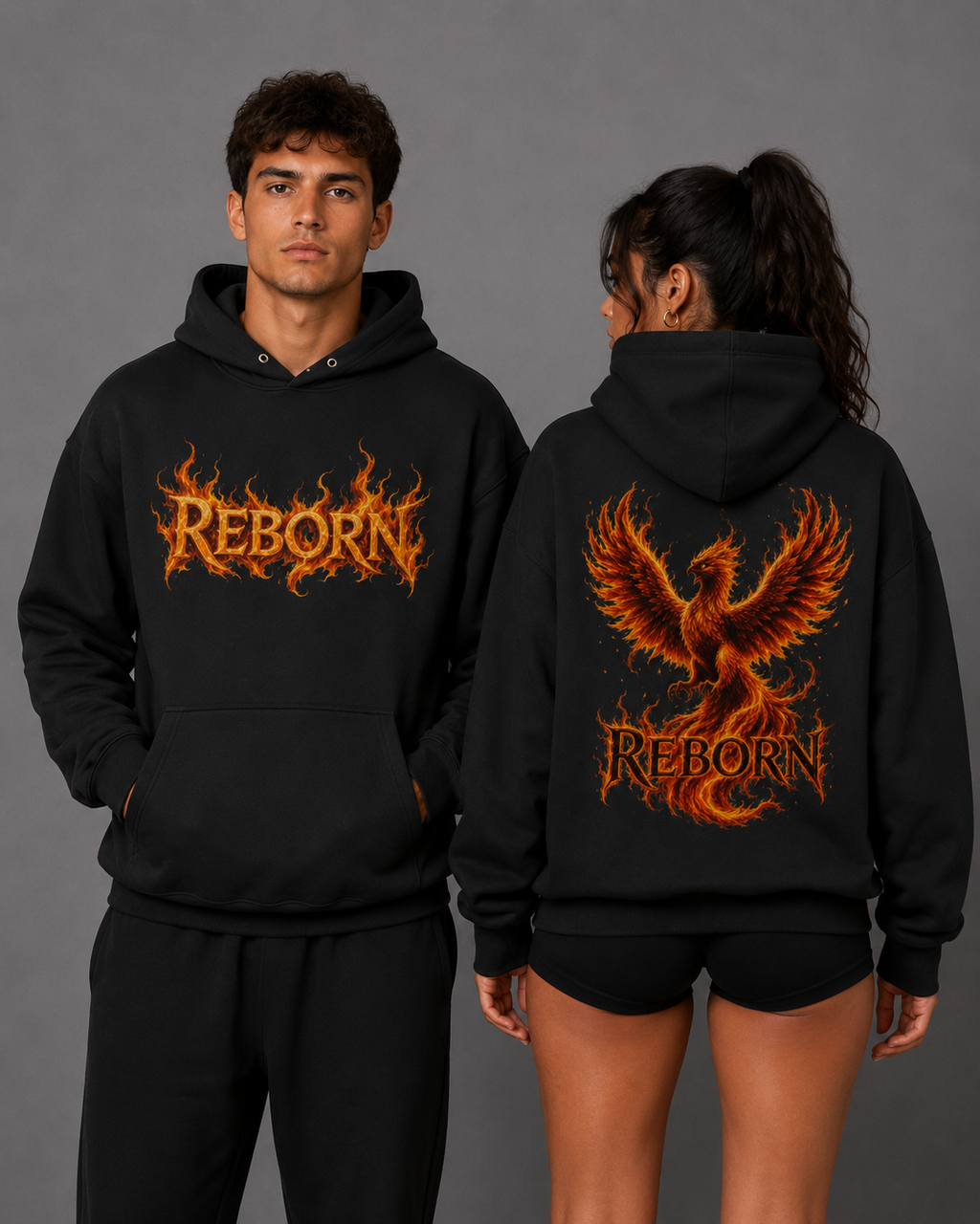 Male and female models wearing black “Reborn” hoodies, showing the fiery orange front lettering and large phoenix back graphic against a gray studio background.