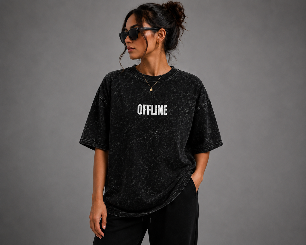 Woman wearing black oversized OFFLINE graphic T-shirt with a washed vintage finish