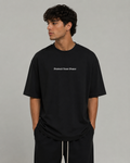 Man wearing black Protect Your Peace oversized T-shirt by Soul Kreations Luxe