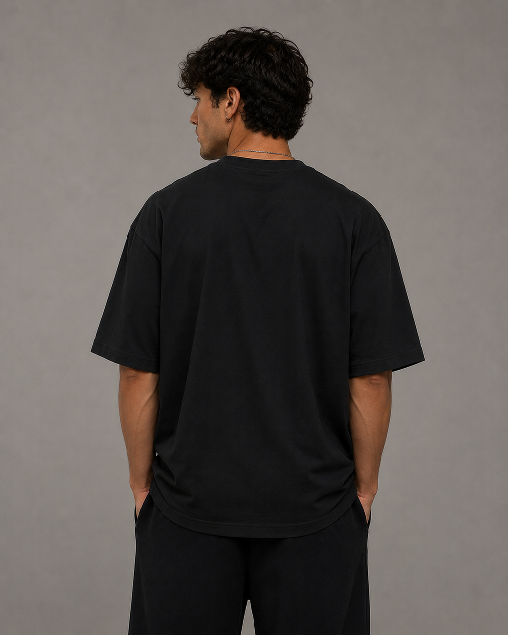 Back view of man wearing black Protect Your Peace oversized T-shirt by Soul Kreations Luxe