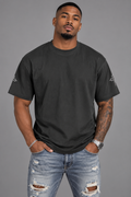 Male model wearing The Way, The Truth, The Life charcoal smoke unisex T-shirt with cross sleeve details.