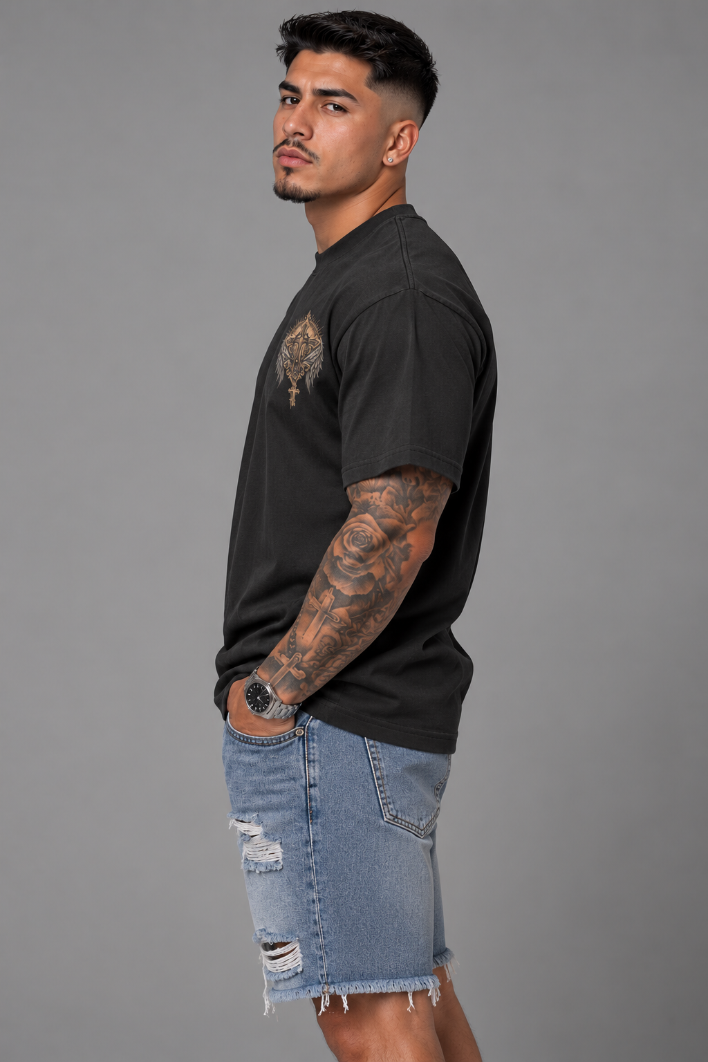 Fallen Angels T-shirt featuring a detailed winged angel with a glowing halo, ornate gothic frame, crosses and antique gold accents. side view of a male.