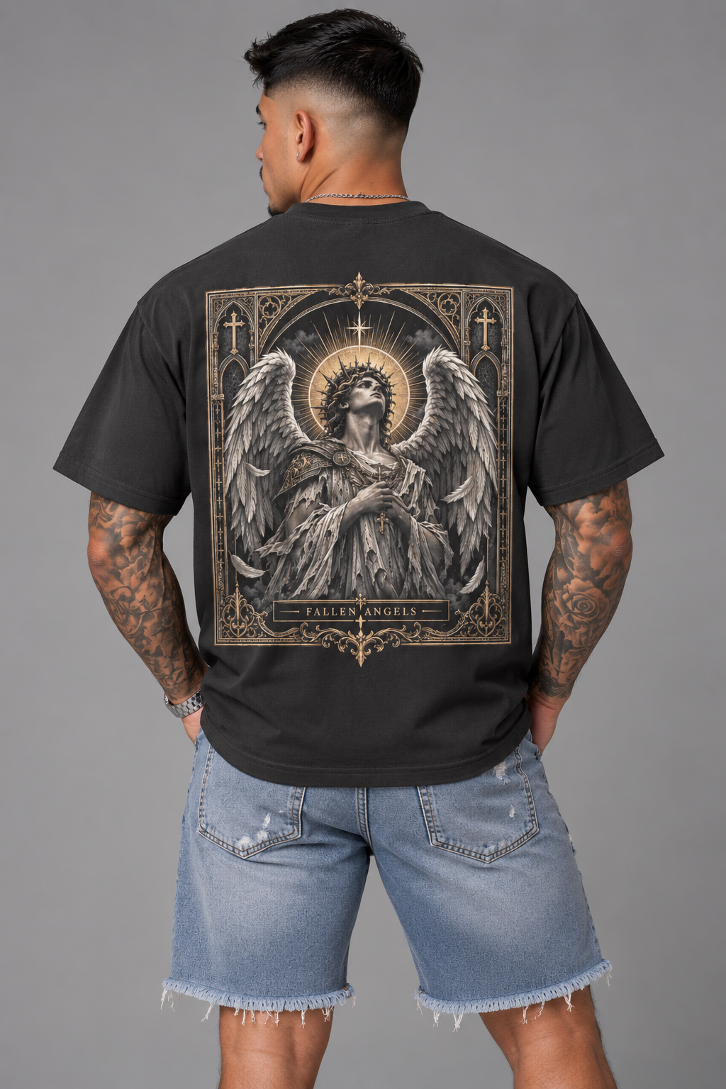 Male model wearing the Fallen Angels T-shirt featuring an ornate winged angel and gothic-inspired back graphic.