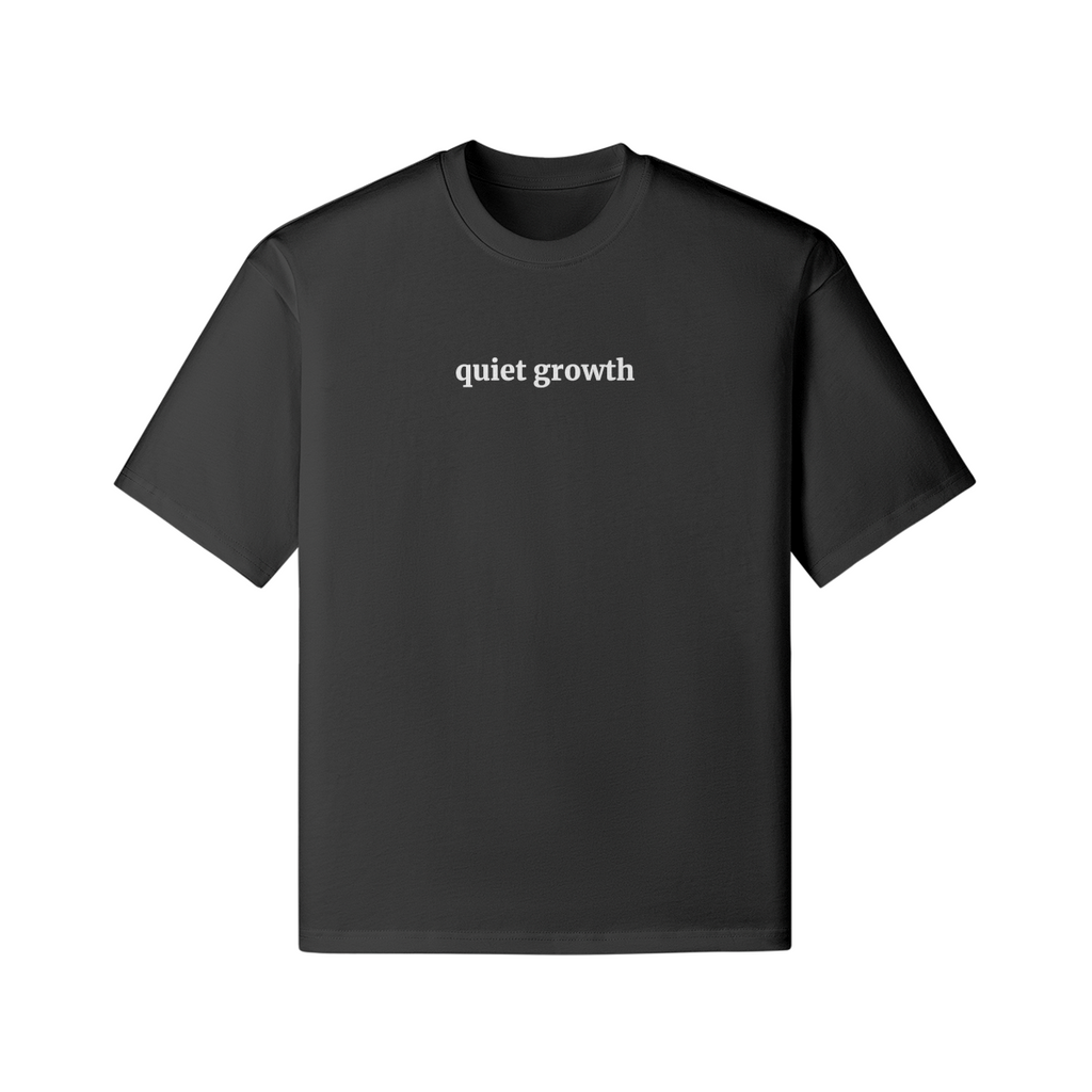 Woman wearing a black t-shirt with 'quiet growth' text, front view